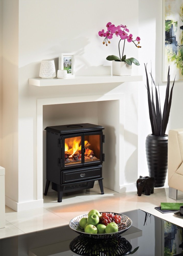 A white fireplace surrounds with a Dimplex OptiMyst Oakhurst electric stove