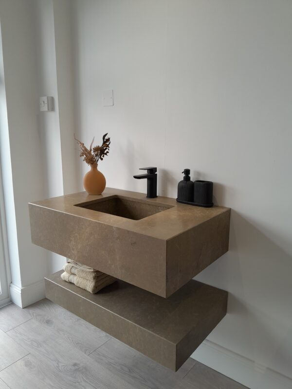 Custom-made bathroom vanity unit crafted in Sierra Elvira marble